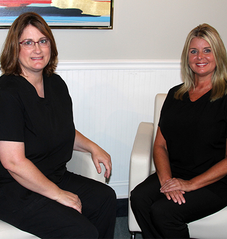 Two smiling dental team members