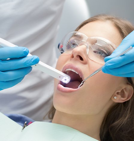 Woman receiving oral cancer screening