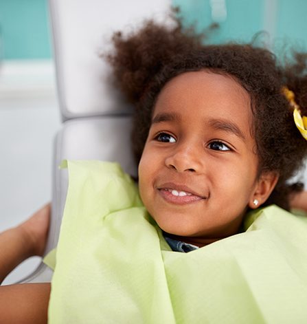 Smiling child in dental exam chair