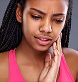 Woman in pain holding jaw