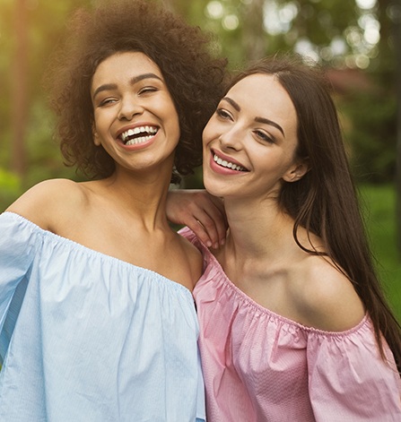 Two women smiling outdoors