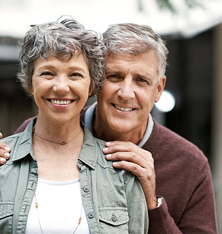 Smiling older man and woman outdoors