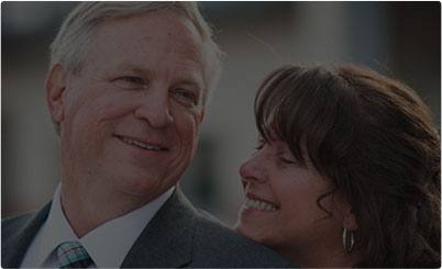 Older man and woman smiling outdoors