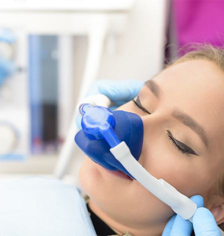 Woman in dental chair with nitrous oxide nose mask